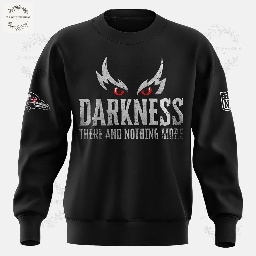A clear front view of the all-black Baltimore Ravens sweatshirt showing the "Darkness" text with red eyes and sleeve logos.