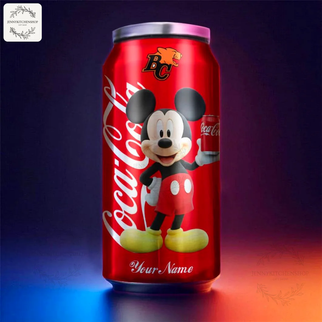 A personalized BC Lions CFL team Coca-Cola tumbler featuring Mickey Mouse, shown in a dramatic studio setting with colored lighting.