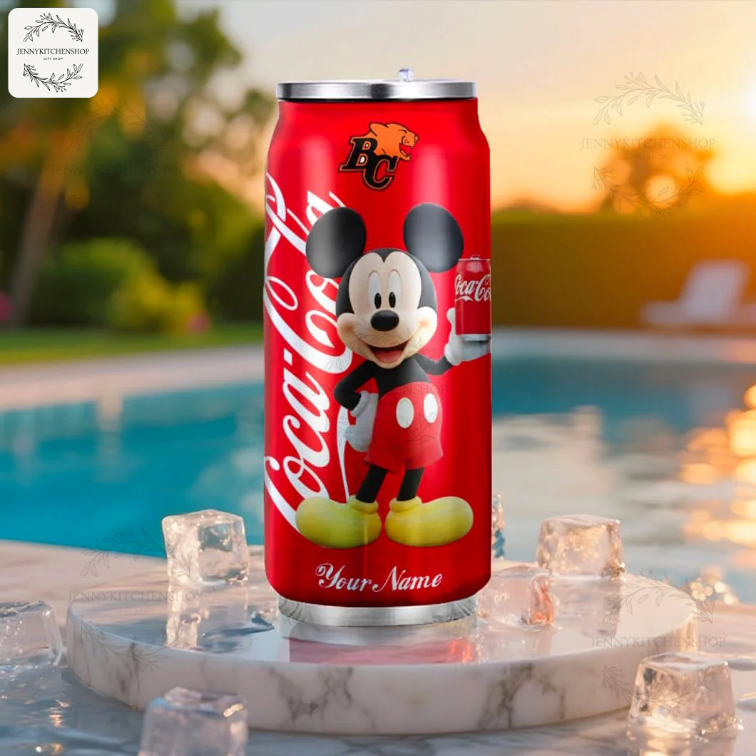 The custom BC Lions Mickey Mouse Coca-Cola tumbler sitting on a marble stand with ice cubes by a swimming pool at sunset.