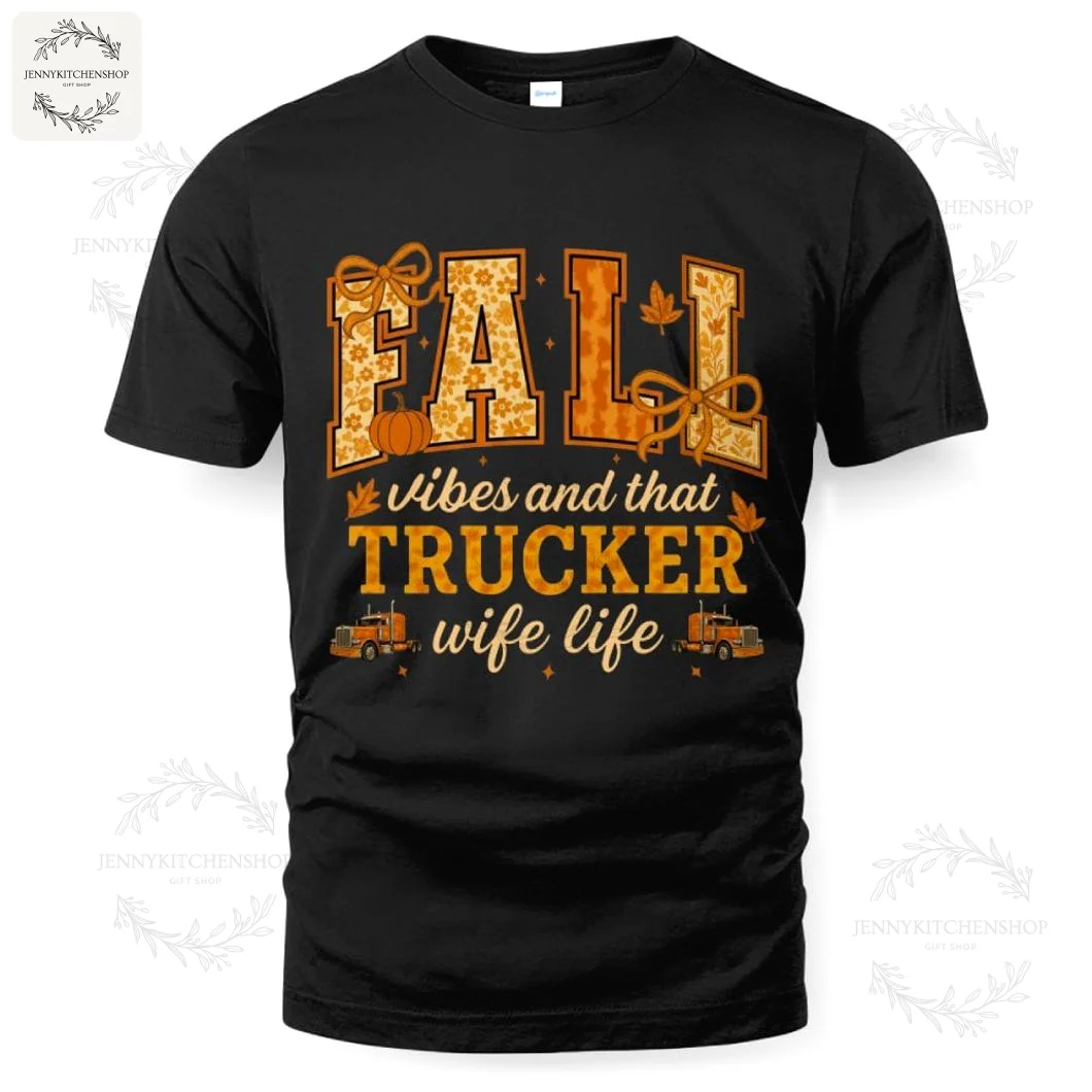 A black t-shirt with an autumn-themed design that reads "Fall vibes and that trucker wife life" with pumpkins and trucks.