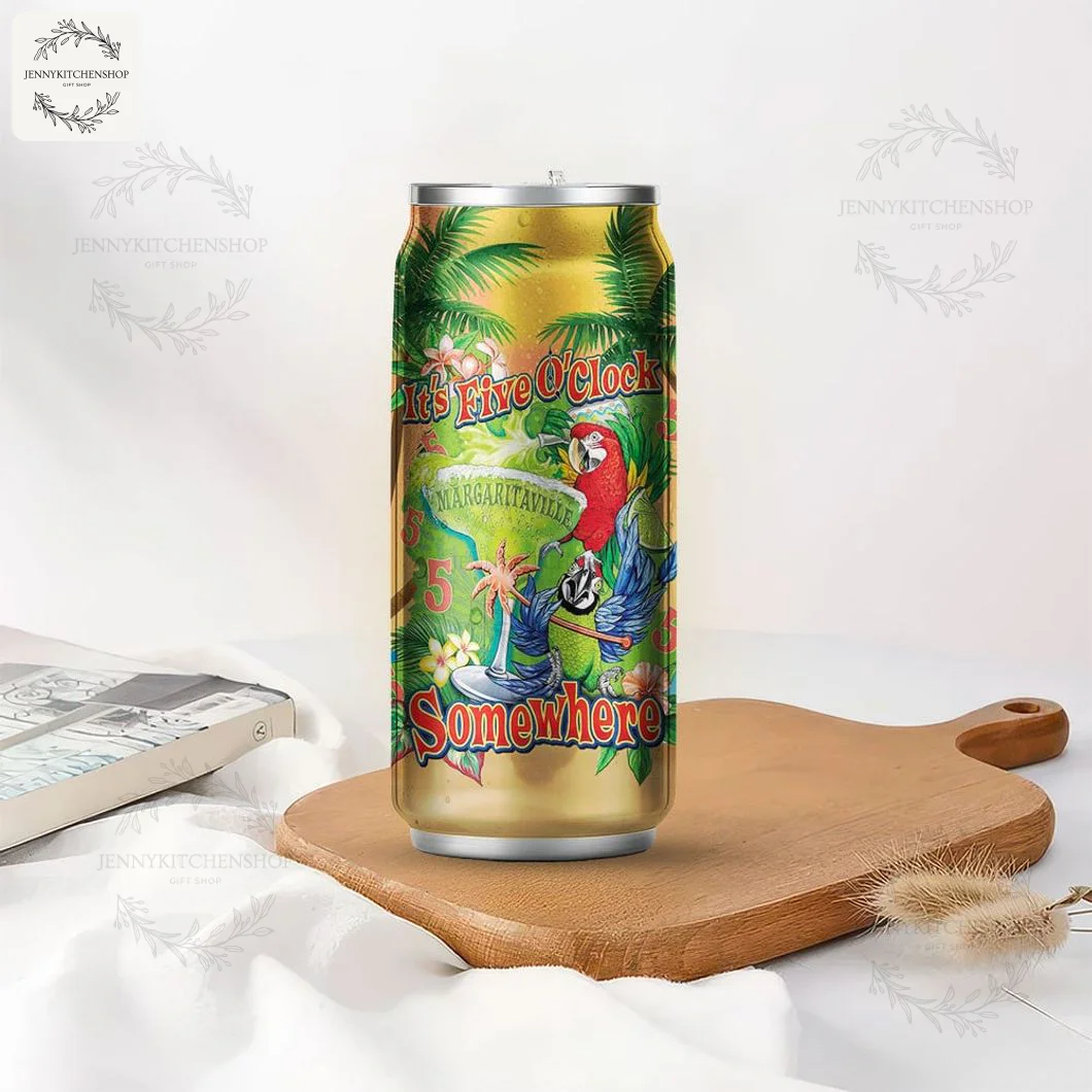 The Jimmy Buffett Margaritaville can-shaped tumbler shown in a lifestyle setting on a wooden board next to a book.