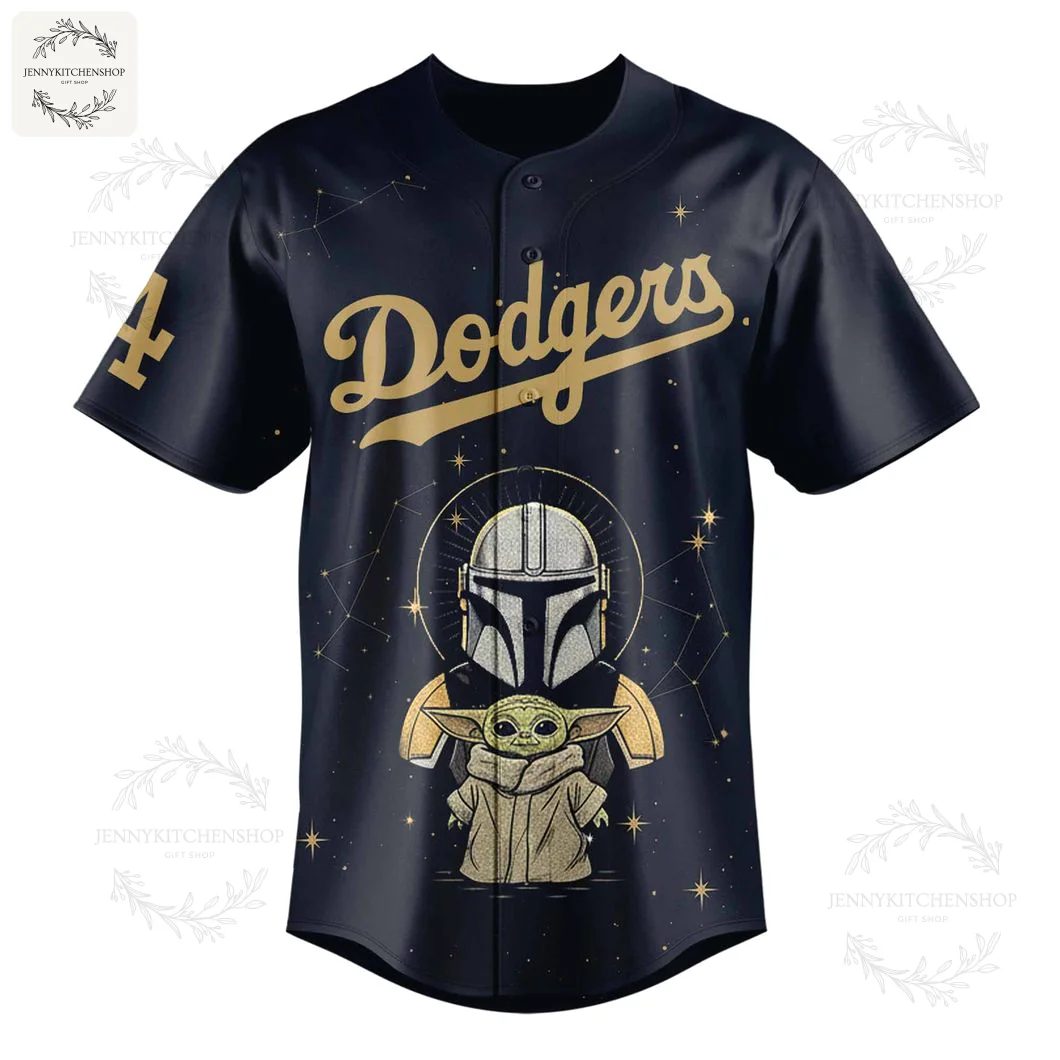 Front of the black LA Dodgers x Mandalorian baseball jersey with gold Dodgers script and a graphic of Grogu and Mando's helmet.
