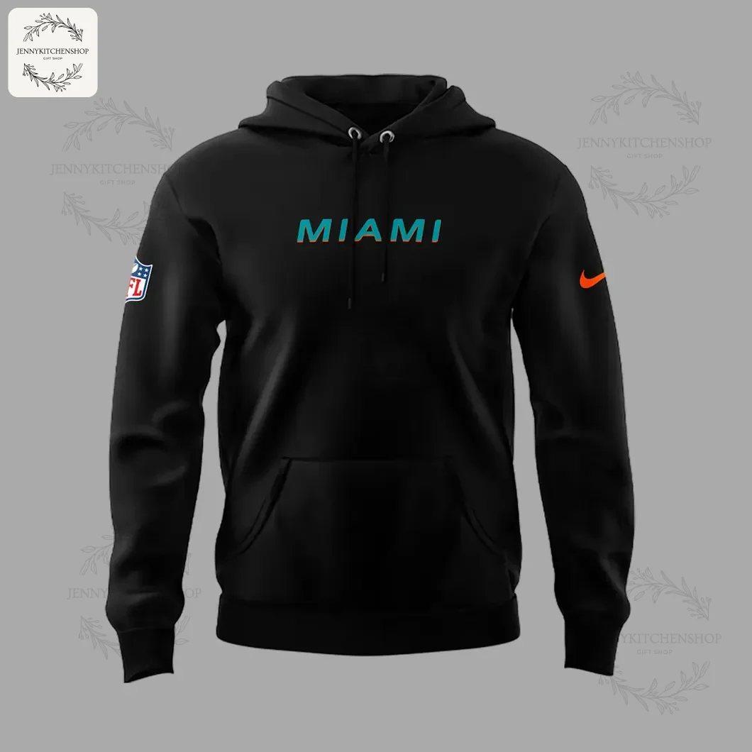 Front of the black Miami Dolphins hoodie featuring the word MIAMI in teal and orange on the chest and an NFL logo on the sleeve.