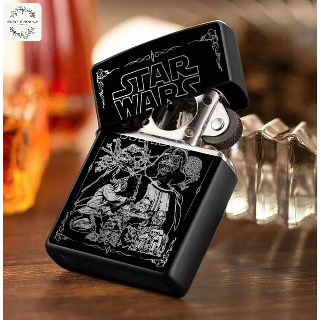 The Star Wars Galactic Saga lighter case is open and resting on a table, showcasing its detailed engraved design and inner mechanism.