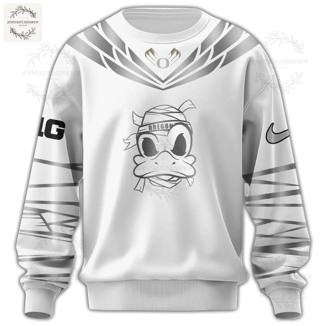 A close-up of the front of the white sweatshirt showing the Oregon Ducks mummy mascot graphic on the chest and wrapped sleeve design.