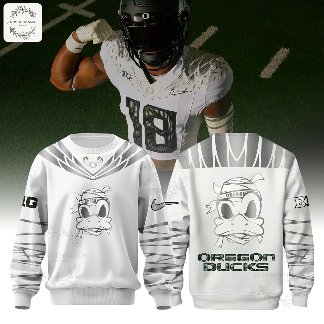 Front and back of the white Oregon Ducks sweatshirt with a mummy duck graphic, displayed with a football player in the background.