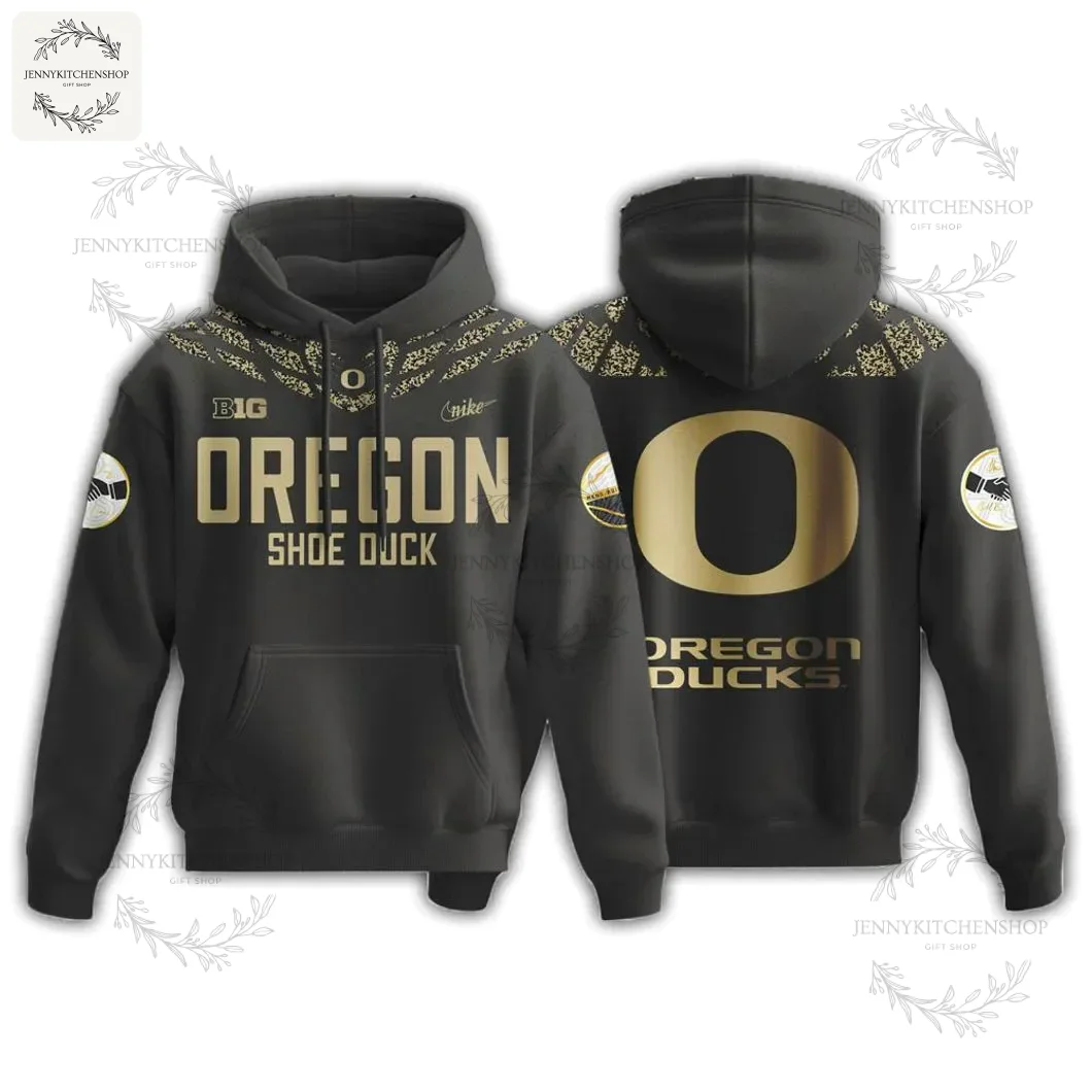 Front and back view of the Oregon Ducks New Shoe Duck 2025 Hoodie, a black pullover with gold graphics and text.