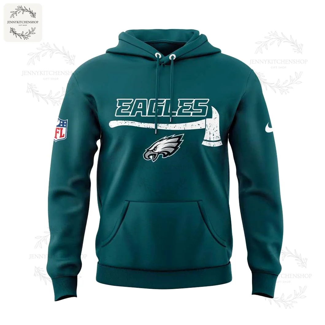 Front view of midnight green hoodie with distressed "EAGLES" wordmark, firefighter axe graphic above the Eagles logo, kangaroo pocket, drawstring hood and visible NFL/Nike sleeve patches.