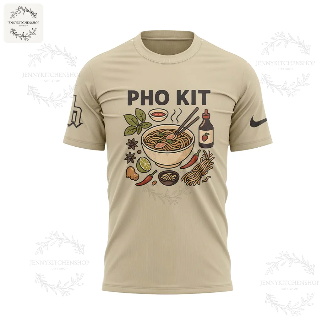 Front of the tan Pho Kit t-shirt featuring a graphic of a steaming bowl of pho with various ingredients like chili and lime.