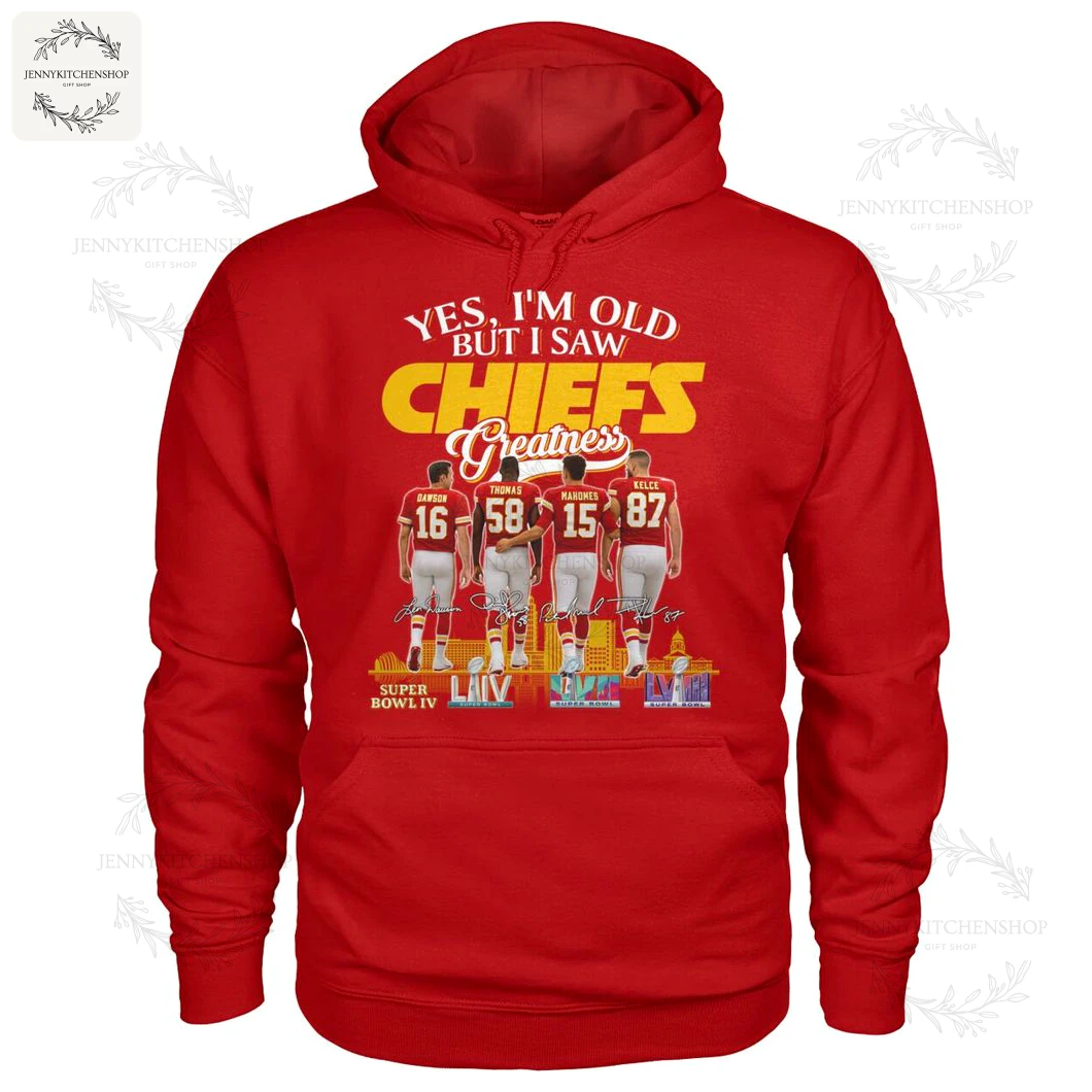 Red pullover hoodie shown front-on with large "CHIEFS Greatness" graphic, featuring four players' backs (Dawson 16, Thomas 58, Mahomes 15, Kelce 87) and Super Bowl illustrations at the bottom