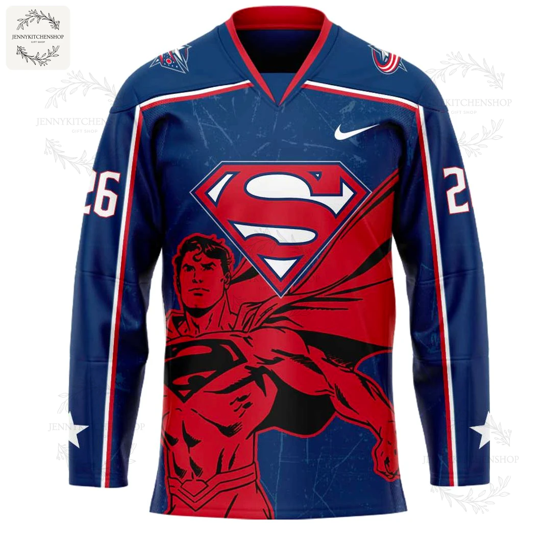 Close-up of the front of the Columbus Blue Jackets Superman jersey, featuring the iconic Superman 'S' shield and hero graphic.