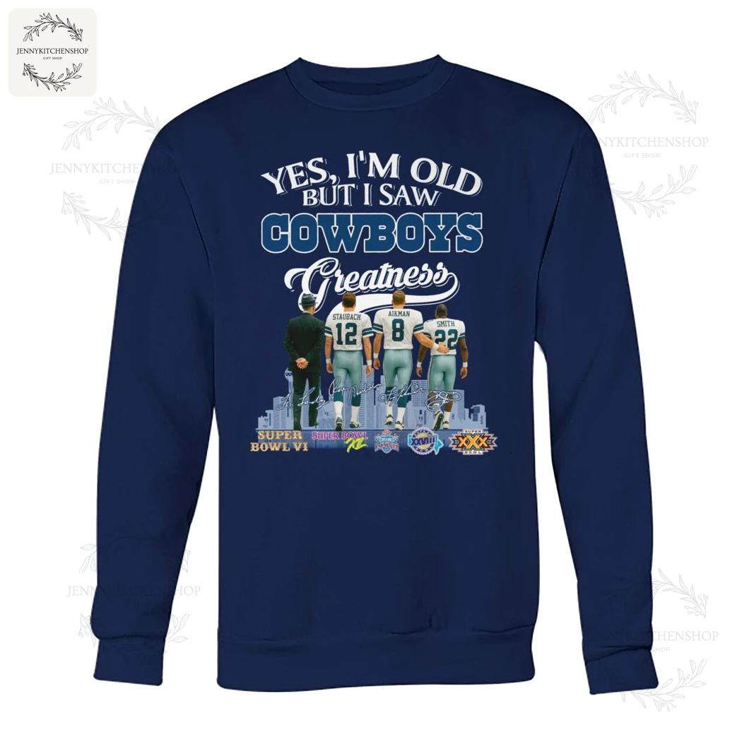 Front view of navy crewneck sweatshirt featuring the same "Yes, I'm Old But I Saw Cowboys Greatness" design with Staubach, Aikman and Smith from behind, skyline and Super Bowl emblems