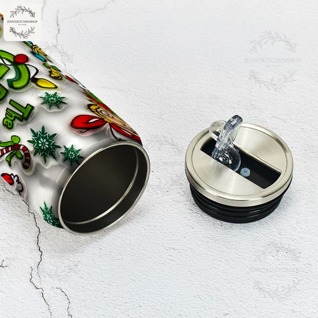 Close-up of the stainless steel interior and spill-proof lid of The Grinch can shaped tumbler, placed on a white marble surface.