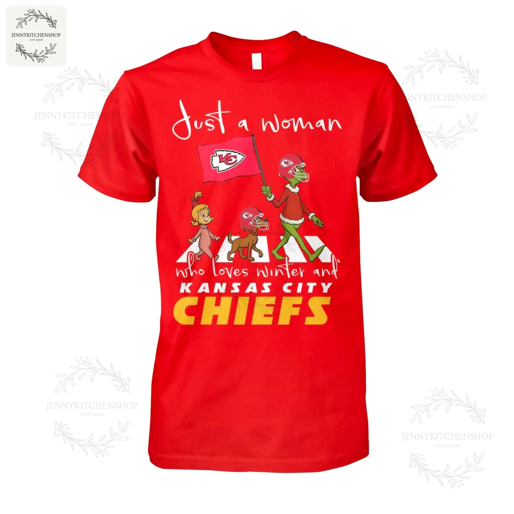 Front view of a red t-shirt for women featuring Grinch characters and the text "Just a Woman who loves winter and Kansas City Chiefs".