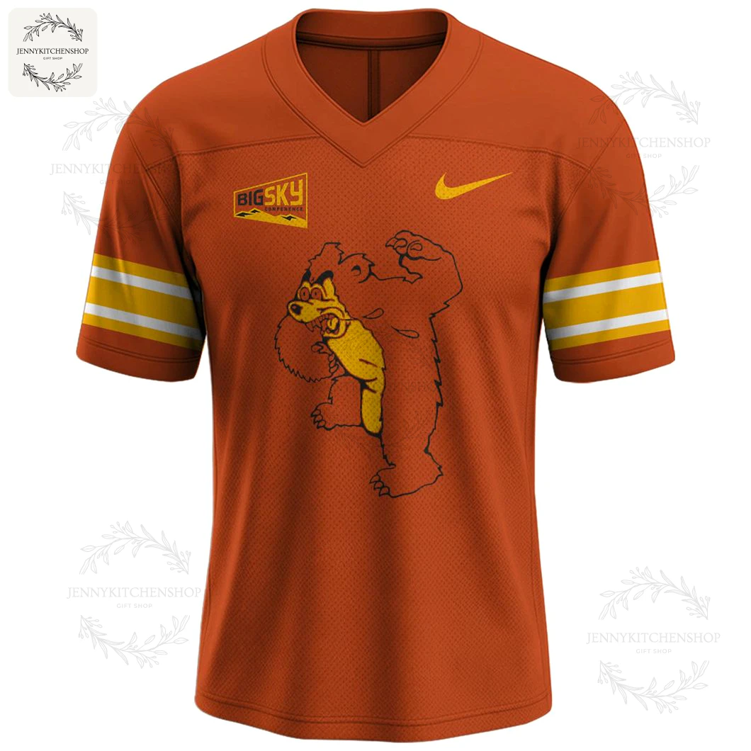 Angled front view of the orange Montana Grizzlies football jersey, featuring a large graphic of Monte the bear mascot flexing.