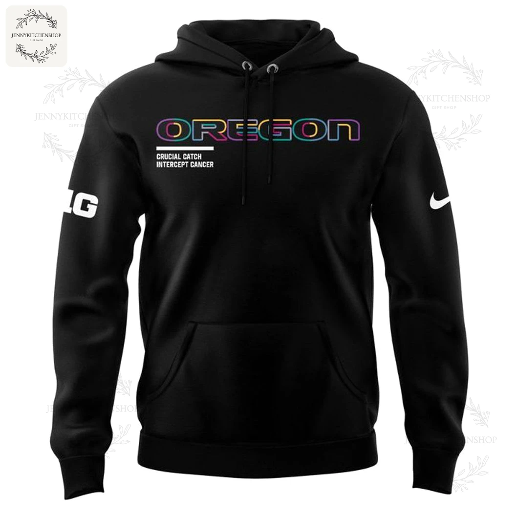 Front View of the Oregon Ducks 2025 Crucial Catch Hoodie Front of the black Oregon Ducks Crucial Catch pullover hoodie with multi-colored 'OREGON' text and Intercept Cancer branding.