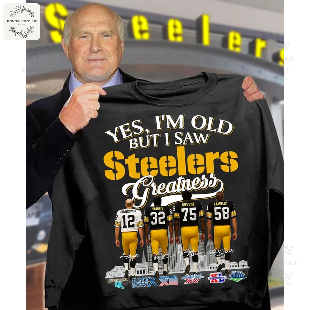Model holding black "Yes, I'm Old But I Saw Steelers Greatness" T-shirt showing back-view illustrations of Bradshaw #12, Harris #32, Greene #75, and Lambert #58 with city skyline and Super Bowl icons