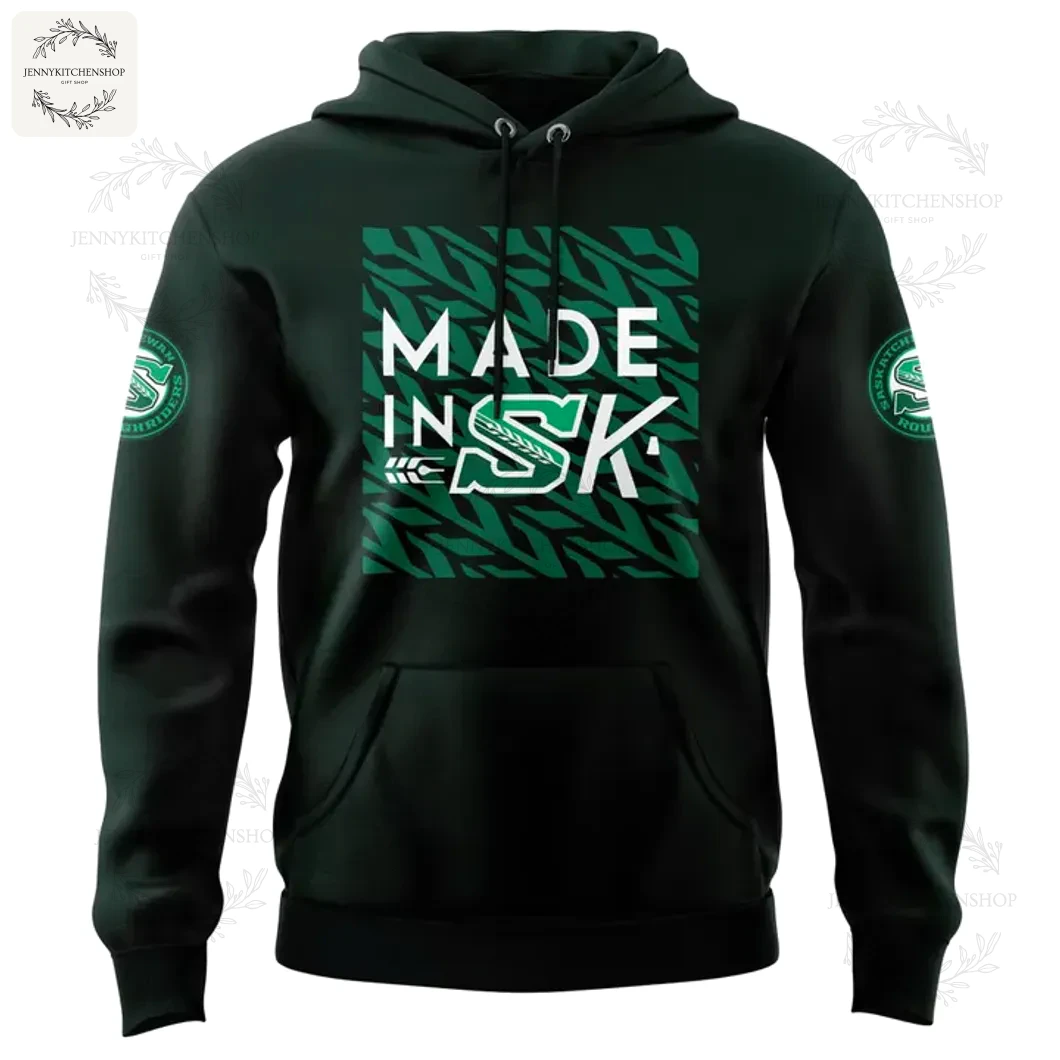 Front of the dark green Saskatchewan Roughriders 2025 hoodie featuring the 'MADE IN SK' graphic and team logos on the sleeves.