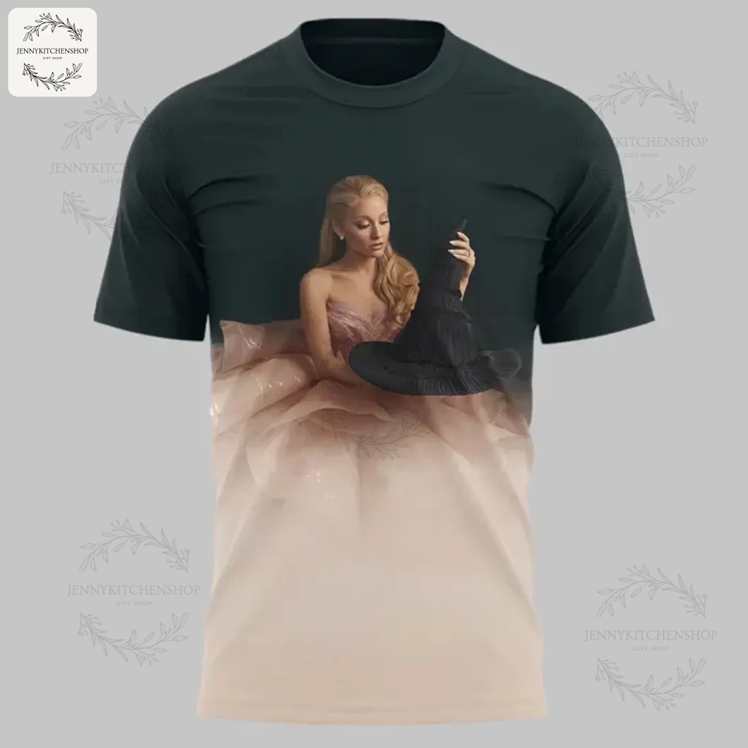 The front of the Wicked movie t-shirt featuring a graphic of Glinda in a pink gown holding a witch's hat on a gradient background.